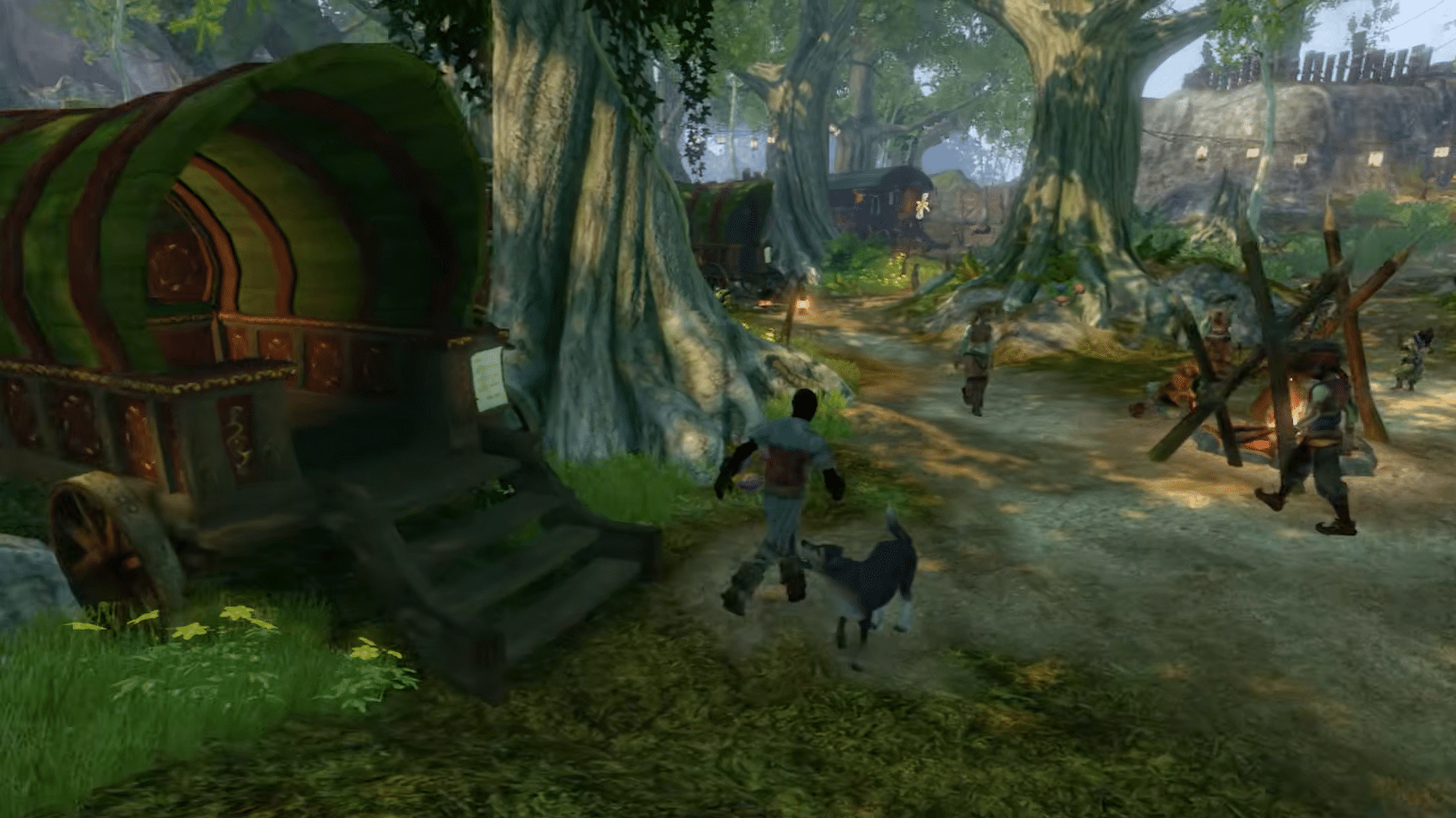 Fable 2 Recomp running natively on PC, with the hero and dog walking past a painted wagon in a forest camp