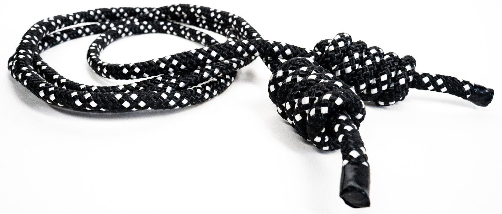 Black and white weighted flow rope with a large knot at each end