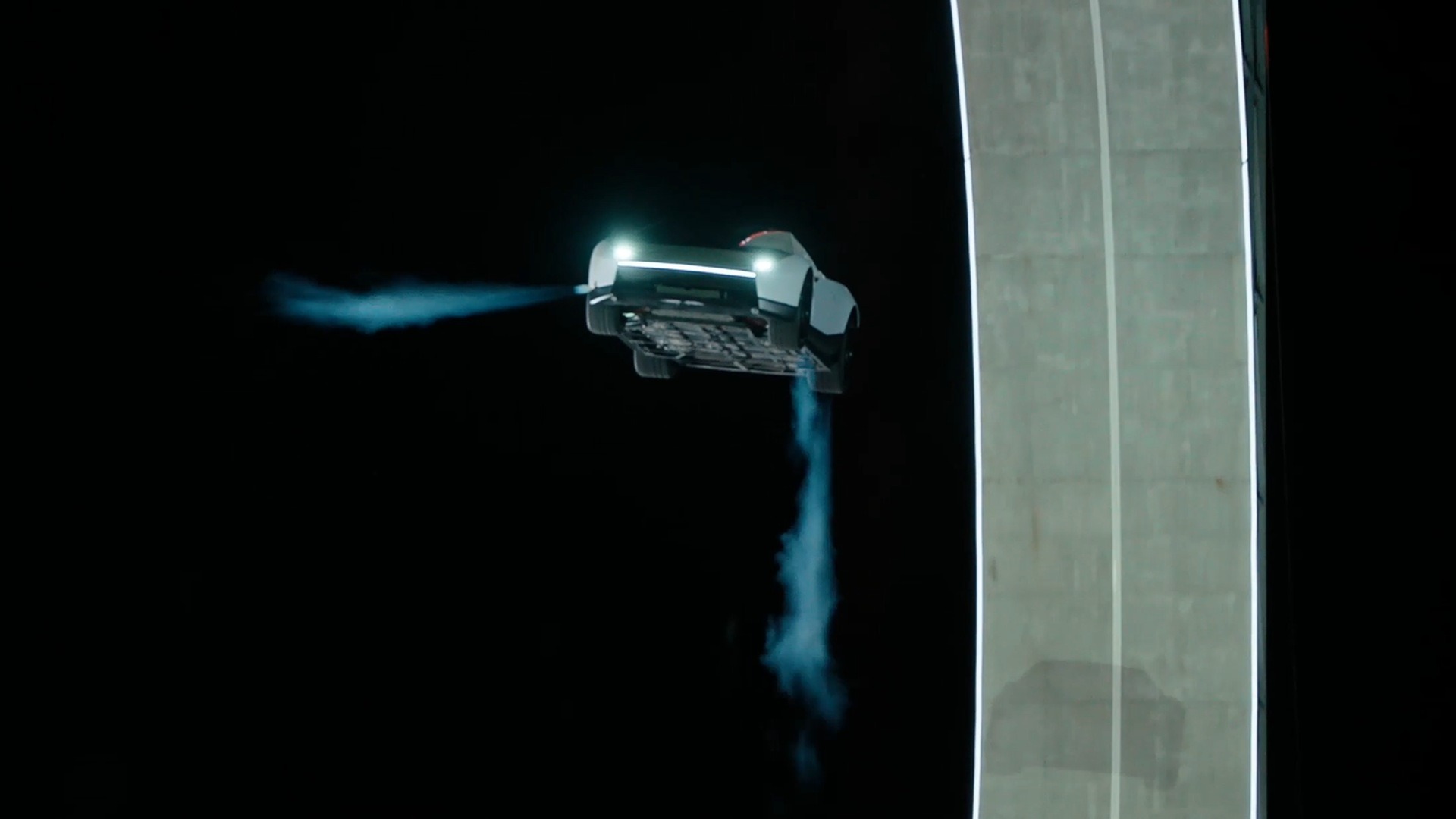 Tesla Roadster airborne with thruster plumes during the McGregor reveal