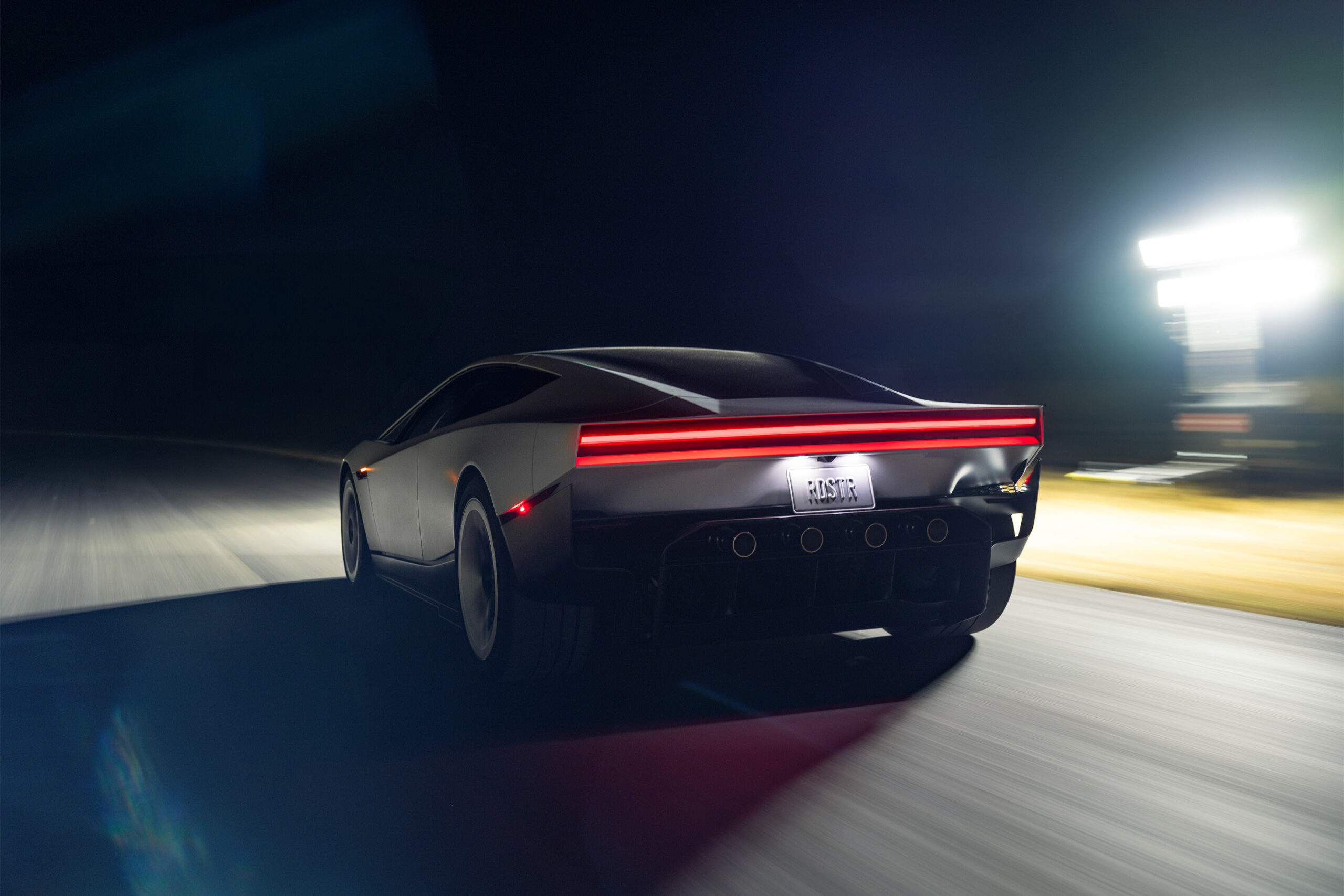 The Roadster at speed on a track at night
